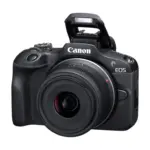 Canon EOS R100 mirrorless camera with RF-S 18-45mm IS STM lens and popup flash open