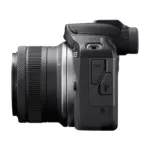 Canon EOS R100 mirrorless camera side view with RF-S 18-45mm lens