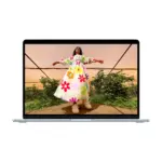 Apple MacBook Air 15-inch M5 in Sky Blue, open, showing a photograph on the 15.3-inch display
