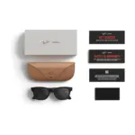 Ray-Ban Meta Wayfarer (Gen 2) smart glasses, Matte Black frame with Grey Transitions lenses, shown with the charging case, cable and documentation supplied in the box.