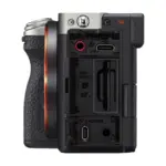 Sony Alpha a7C II camera body, Silver - side view with terminal covers open