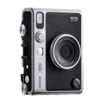 Fujifilm instax mini Evo hybrid instant camera in black, angled view showing the lens dial and print lever