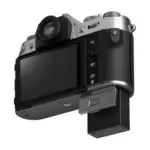 Fujifilm X-T50 mirrorless camera body in Silver - angled rear view with the screen tilted out.