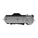 Fujifilm X-T50 mirrorless camera body in Silver - underside view showing the tripod socket and battery door.