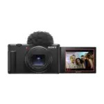 Sony ZV-1 II vlog camera in black, front view with the ZEISS Vario-Sonnar T* zoom lens and the screen rotated forward