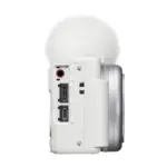 Sony ZV-1F vlog camera in white, side view showing the microphone and USB Type-C ports